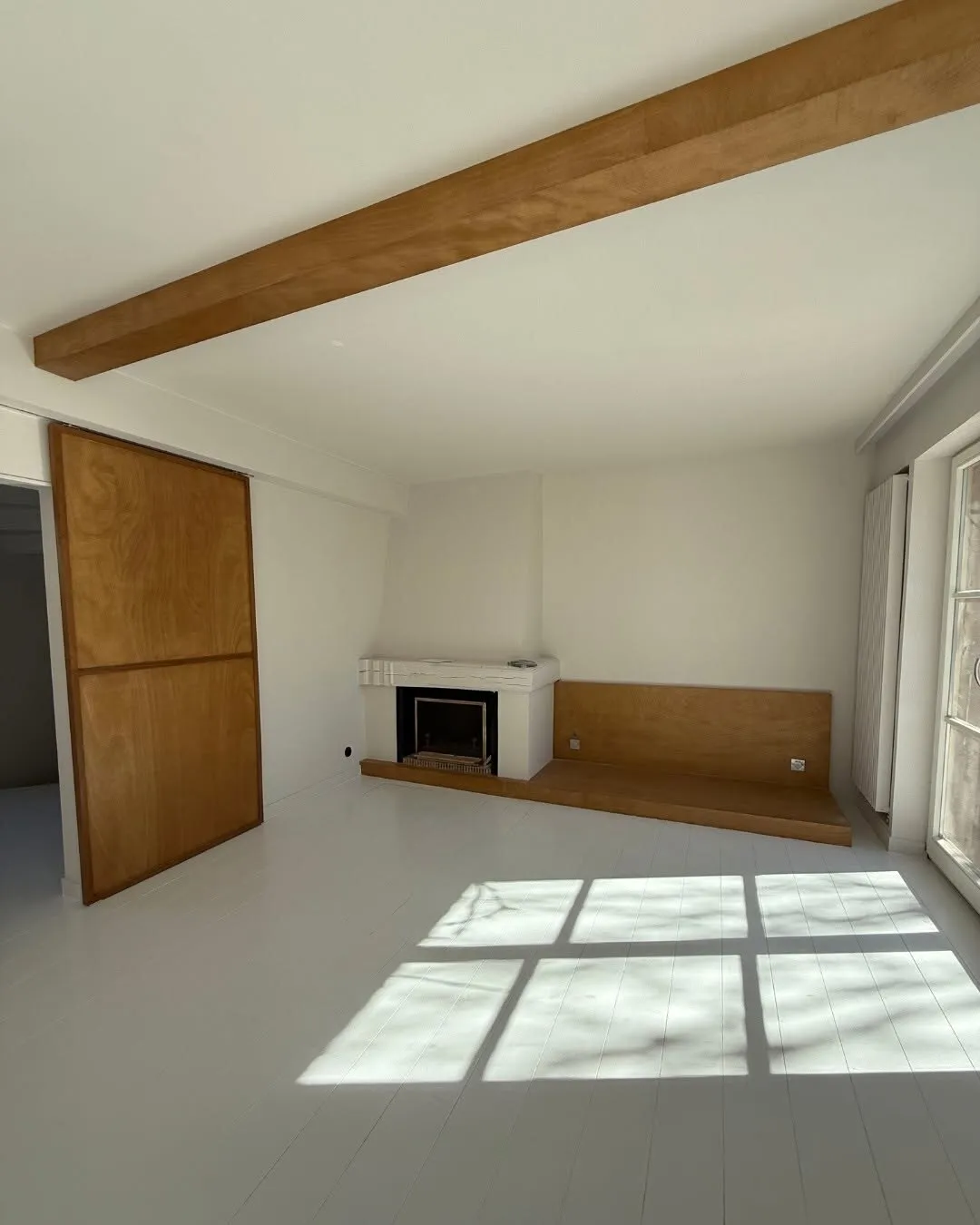 Living room with a fireplace and a bespoke timber bench